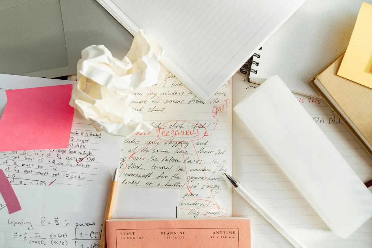 Image of a messy desk with scribbled notes and papers.